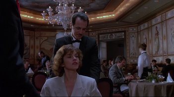 Movie still from “Dead Ringers” (1988), directed by David Cronenberg – A man and a woman sitting in front of each other in a room; Medium shot, Low angle