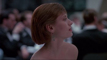 Movie still from “Dead Ringers” (1988), directed by David Cronenberg – A woman with short red hair wearing a pair of earrings; Close Up shot, Low angle