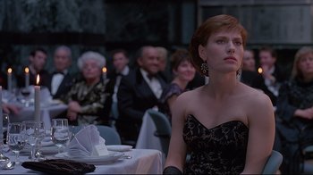Movie still from “Dead Ringers” (1988), directed by David Cronenberg – A group of people sitting at a table with plates; Medium shot, Low angle