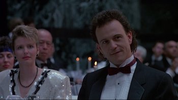 Movie still from “Dead Ringers” (1988), directed by David Cronenberg – A man in a tuxedo standing in front of other people; Close Up shot, Low angle