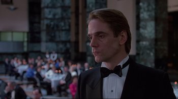 Movie still from “Dead Ringers” (1988), directed by David Cronenberg – A man in a tuxedo standing in front of a crowd; Close Up shot, Low angle