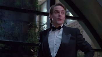 Movie still from “Dead Ringers” (1988), directed by David Cronenberg – A man in a tuxedo standing in front of a window; Close Up shot, Low angle
