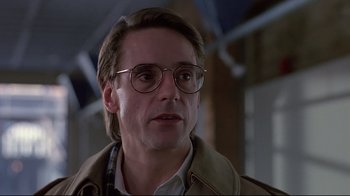 Movie still from “Dead Ringers” (1988), directed by David Cronenberg – A person wearing glasses and a jacket; Close Up shot, Low angle