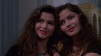 Movie still from “Dead Ringers” (1988), directed by David Cronenberg – Two young women pose for a picture together; Close Up shot, Low angle