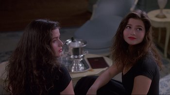 Movie still from “Dead Ringers” (1988), directed by David Cronenberg – Two women sitting on the floor looking at each other; Medium shot, Over the shoulder angle