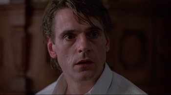 Movie still from “Dead Ringers” (1988), directed by David Cronenberg – A person wearing a white shirt; Close Up shot, Low angle