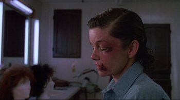Movie still from “Dead Ringers” (1988), directed by David Cronenberg – A young boy with makeup on his face; Close Up shot, Over the shoulder angle