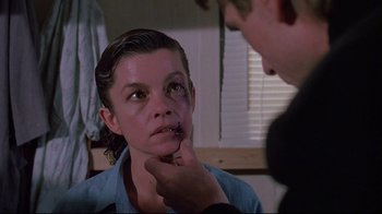 Movie still from “Dead Ringers” (1988), directed by David Cronenberg – A young person is being examined by a doctor; Close Up shot, Over the shoulder angle