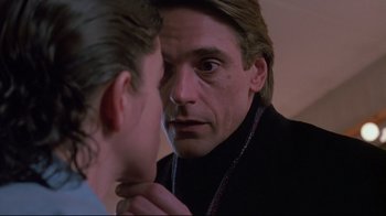 Movie still from “Dead Ringers” (1988), directed by David Cronenberg – A man looking at his reflection in a mirror; Close Up shot, Over the shoulder angle