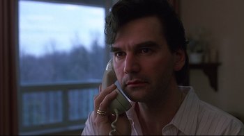 Movie still from “Dead Ringers” (1988), directed by David Cronenberg – A person talking on a phone; Close Up shot, Low angle