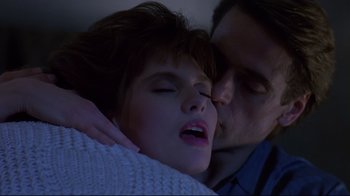 Movie still from “Dead Ringers” (1988), directed by David Cronenberg – A man and a woman kissing in the dark; Close Up shot, Low angle
