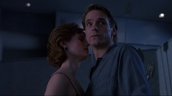 Movie still from “Dead Ringers” (1988), directed by David Cronenberg – A man and a woman standing next to each other in a room; Close Up shot, Low angle