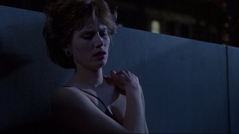 Movie still from “Dead Ringers” (1988), directed by David Cronenberg – A beautiful woman with short brown hair is posing for the camera; Close Up shot, Low angle