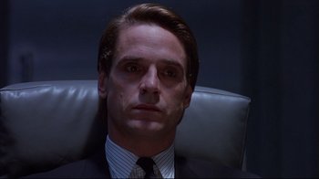 Movie still from “Dead Ringers” (1988), directed by David Cronenberg – A person wearing a suit and tie; Close Up shot, Low angle