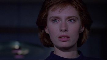 Movie still from “Dead Ringers” (1988), directed by David Cronenberg – A person with short red hair; Close Up shot, Low angle