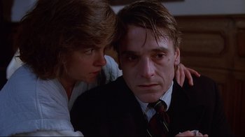 Movie still from “Dead Ringers” (1988), directed by David Cronenberg – A man and a woman sitting next to each other in a room; Close Up shot, Low angle