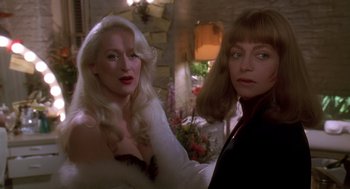 Movie still from “Death Becomes Her” (1992), directed by Robert Zemeckis – Two women are standing next to each other in a room; Close Up shot, Over the shoulder angle