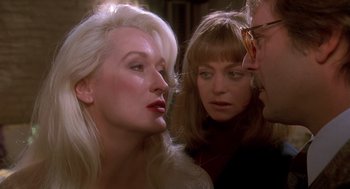 Movie still from “Death Becomes Her” (1992), directed by Robert Zemeckis – Two women and a man are talking to each other; Close Up shot, Over the shoulder angle