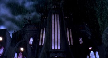 Movie still from “Death Becomes Her” (1992), directed by Robert Zemeckis – A building that has been lit up at night time; Extreme Wide shot, Low angle