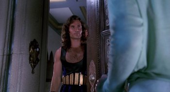 Movie still from “Death Becomes Her” (1992), directed by Robert Zemeckis – A man with a hairy chest standing in front of a mirror; Medium shot, Over the shoulder angle