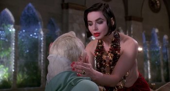 Movie still from “Death Becomes Her” (1992), directed by Robert Zemeckis – A woman in a red top is talking to another woman; Close Up shot, Over the shoulder angle