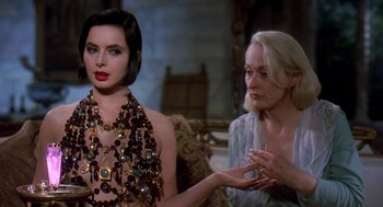 Movie still from “Death Becomes Her” (1992), directed by Robert Zemeckis – Two women sitting on a couch wearing necklaces; Close Up shot, Over the shoulder angle