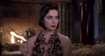 Movie still from “Death Becomes Her” (1992), directed by Robert Zemeckis – A woman wearing a necklace and posing for a picture; Close Up shot, Over the shoulder angle