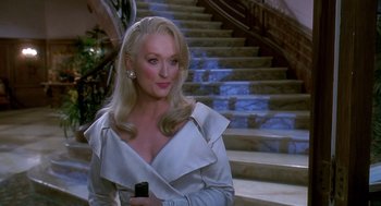Movie still from “Death Becomes Her” (1992), directed by Robert Zemeckis – A woman with long blonde hair holding a cell phone; Medium shot, Over the shoulder angle
