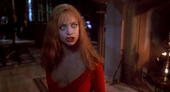 Movie still from “Death Becomes Her” (1992), directed by Robert Zemeckis – A woman in a red dress with blue eyes and red hair; Close Up shot, Over the shoulder angle