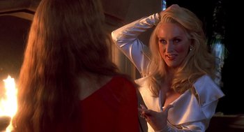 Movie still from “Death Becomes Her” (1992), directed by Robert Zemeckis – A woman in a white shirt is looking in the mirror; Close Up shot, Over the shoulder angle