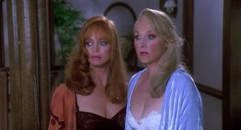 Movie still from “Death Becomes Her” (1992), directed by Robert Zemeckis – Two beautiful women standing next to each other in a room; Close Up shot, High angle