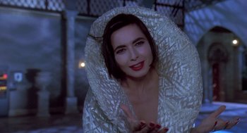 Movie still from “Death Becomes Her” (1992), directed by Robert Zemeckis – A beautiful woman with red lipstick wearing a white jacket; Close Up shot, High angle