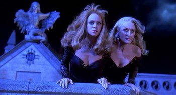 Movie still from “Death Becomes Her” (1992), directed by Robert Zemeckis – A couple of women standing next to each other on stairs; Medium shot, Low angle
