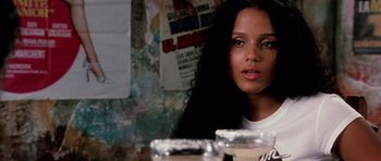 Movie still from “Death Proof” (2007), directed by Quentin Tarantino – A woman with long black hair sitting at a table; Close Up shot, Over the shoulder angle
