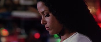 Movie still from “Death Proof” (2007), directed by Quentin Tarantino – A woman's face in a dark room; Close Up shot, Low angle