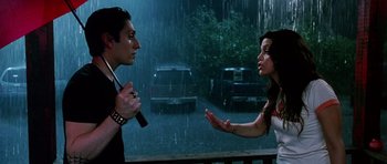 Movie still from “Death Proof” (2007), directed by Quentin Tarantino – A man and a woman talking in the rain; Medium shot, Over the shoulder angle