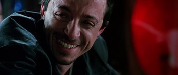 Movie still from “Death Proof” (2007), directed by Quentin Tarantino – A person smiling; Close Up shot, Over the shoulder angle