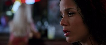 Movie still from “Death Proof” (2007), directed by Quentin Tarantino – A woman's face in front of a blurry background; Close Up shot, Over the shoulder angle