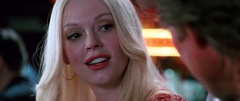 Movie still from “Death Proof” (2007), directed by Quentin Tarantino – A person with long blonde hair; Close Up shot, Over the shoulder angle