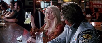 Movie still from “Death Proof” (2007), directed by Quentin Tarantino – A woman sitting at a table in front of a man; Medium shot, Over the shoulder angle