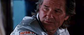 Movie still from “Death Proof” (2007), directed by Quentin Tarantino – A person wearing a silver jacket; Close Up shot, Low angle