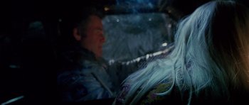 Movie still from “Death Proof” (2007), directed by Quentin Tarantino – A man sitting in the back seat of a car; Close Up shot, Over the shoulder angle