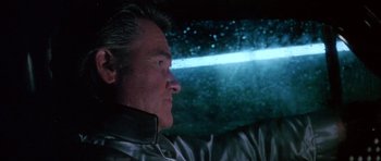 Movie still from “Death Proof” (2007), directed by Quentin Tarantino – A person sitting in a car at night; Close Up shot, Low angle