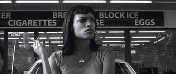 Movie still from “Death Proof” (2007), directed by Quentin Tarantino – Black and white photograph of a woman in front of a building; Close Up shot, Low angle