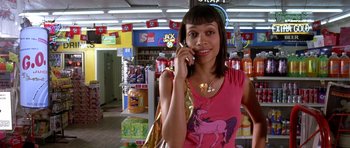 Movie still from “Death Proof” (2007), directed by Quentin Tarantino – A woman talking on a cell phone in a store; Medium shot, High angle