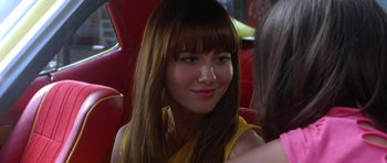 Movie still from “Death Proof” (2007), directed by Quentin Tarantino – A person sitting in a car; Close Up shot, Over the shoulder angle