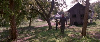 Movie still from “Death Proof” (2007), directed by Quentin Tarantino – A man and a woman are walking in a field; Wide shot, Low angle