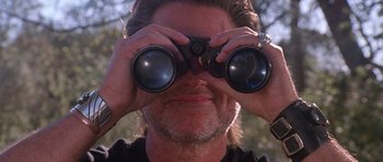 Movie still from “Death Proof” (2007), directed by Quentin Tarantino – A person looking through binoculars; Close Up shot, Low angle