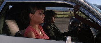 Movie still from “Death Proof” (2007), directed by Quentin Tarantino – A woman driving a car with another woman sitting in the passenger seat; Close Up shot, Over the shoulder angle