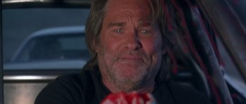 Movie still from “Death Proof” (2007), directed by Quentin Tarantino – A person wearing a black shirt; Close Up shot, Over the shoulder angle